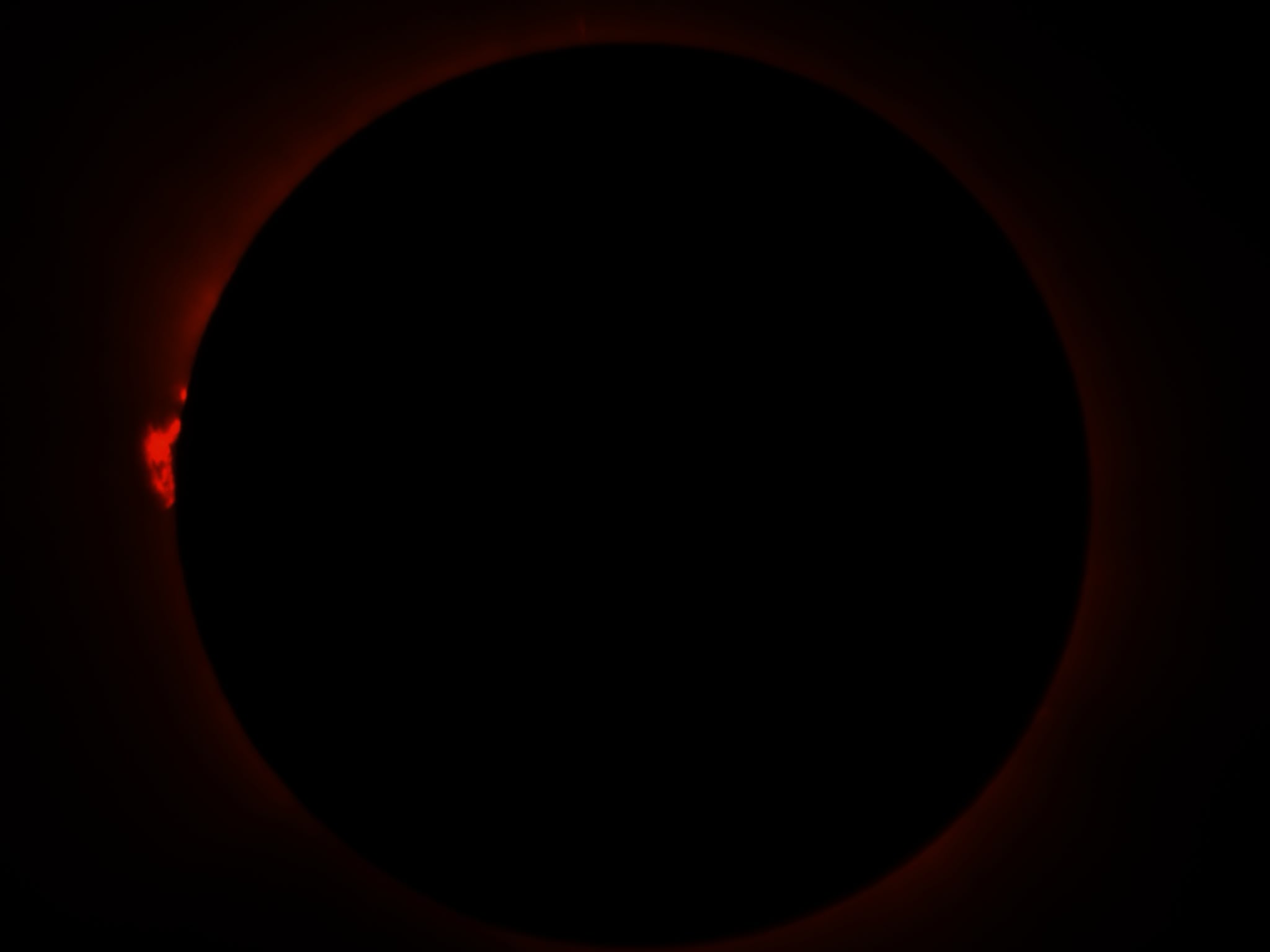 A total eclipse, with a solar prominence visible on the left-hand side. A total eclipse, with a solar prominence visible on the left-hand side.